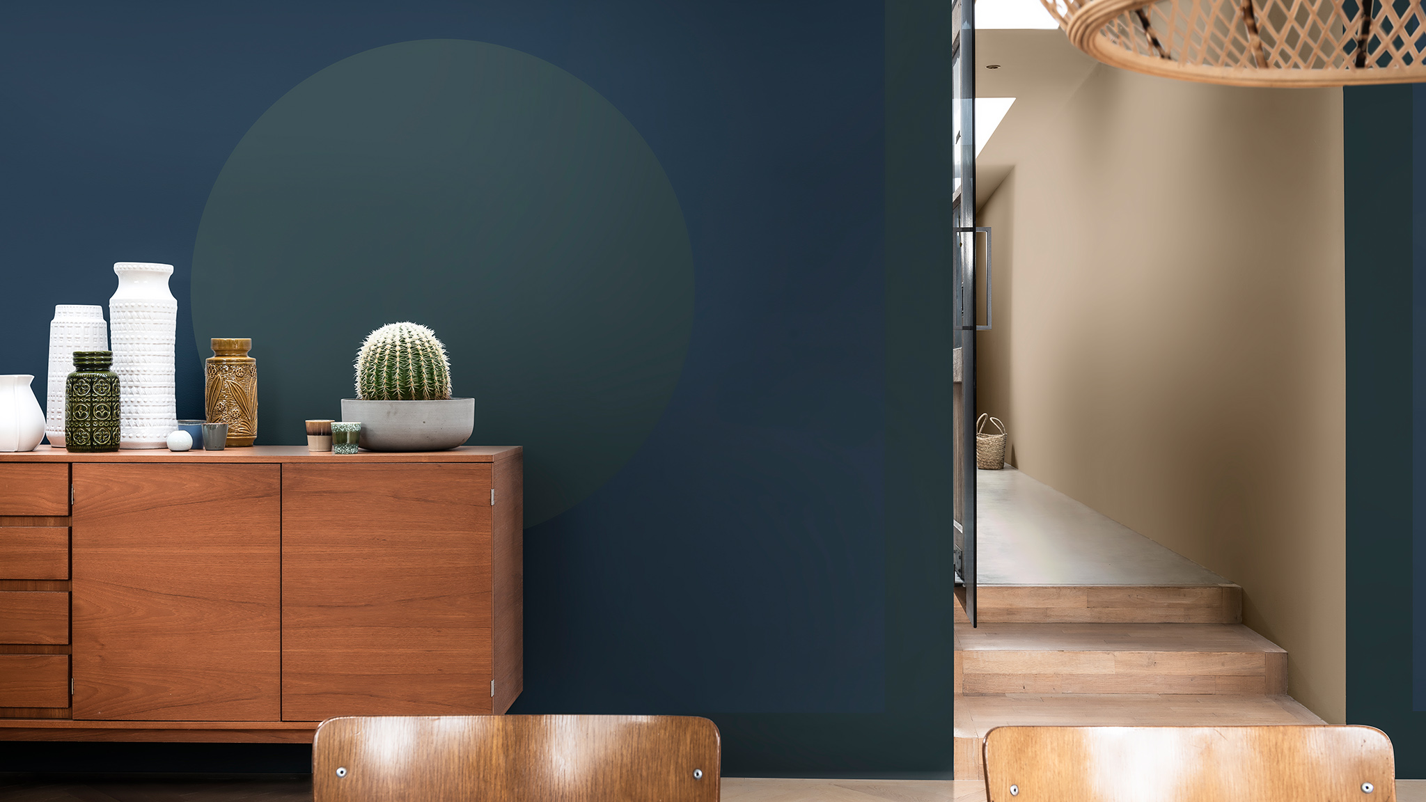 Wooden cabinet against a blue wall with green circle Sadolin_CF21_2021_metų_spalva_Žemiškos_spalvos_Lietuva_4
